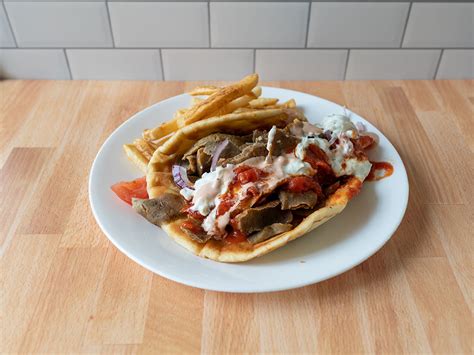 Golden gyros - King Salad. Lettuce, tomatoes, onions, cucumbers, mixed peppers, carrots, olives, banana pepper, pickles, 2 grape leaves and choice of gyro meat.